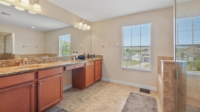 3862 Tristram Loop, Land O Lakes, FL 34638 - full bathroom featuring vanity, tiled shower, and baseboards
