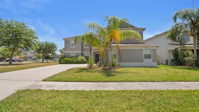 3862 Tristram Loop, Land O Lakes, FL 34638 - view of front of home with a front yard, concrete driveway, and stucco siding
