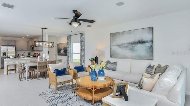 12469 Gust Ct, Hudson, FL 34669 - living area with ceiling fan and light tile patterned floors