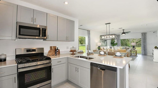 12469 Gust Ct, Hudson, FL 34669 - kitchen with appliances with stainless steel finishes, a sink, gray cabinets, a peninsula, and recessed lighting