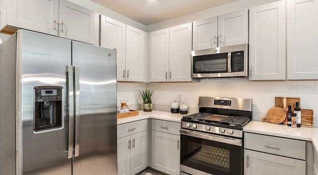 12469 Gust Ct, Hudson, FL 34669 - kitchen featuring stainless steel appliances, light countertops, and gray cabinetry
