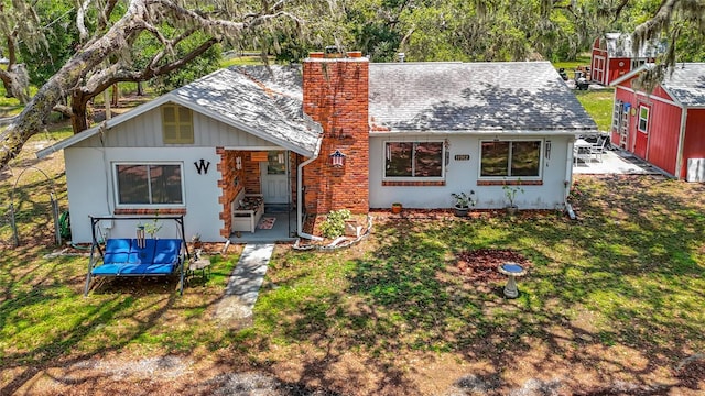 11912 Mcmullen Loop, Riverview, FL 33569 - view of front of house featuring a chimney, a front yard, and a shingled roof