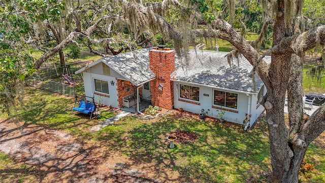 11912 Mcmullen Loop, Riverview, FL 33569 - view of front of property with a chimney, roof with shingles, and stucco siding