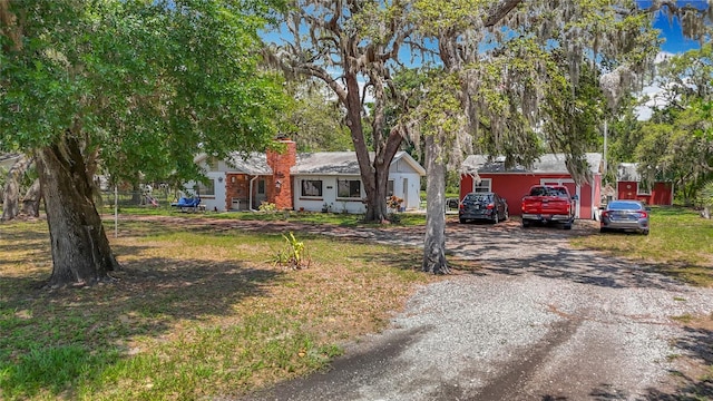 11912 Mcmullen Loop, Riverview, FL 33569 - view of front of property with driveway and a chimney