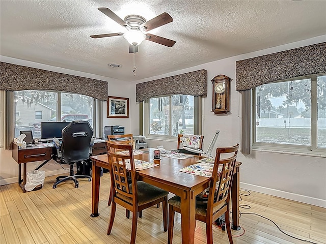 11912 Mcmullen Loop, Riverview, FL 33569 - dining area with a textured ceiling, a ceiling fan, an office area, light wood finished floors, and baseboards