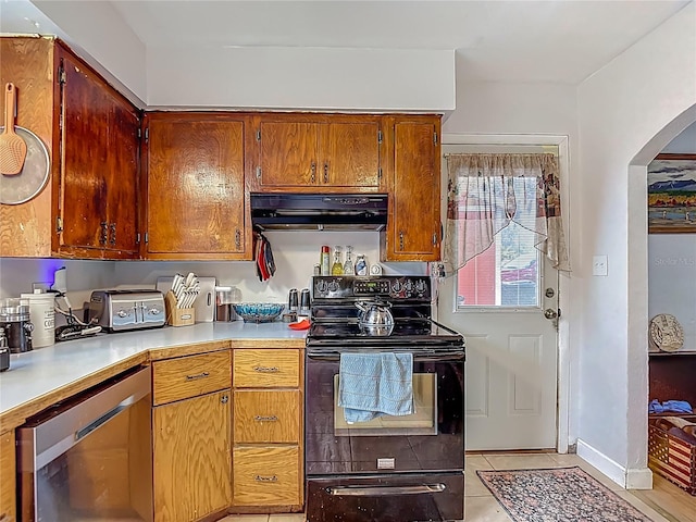 11912 Mcmullen Loop, Riverview, FL 33569 - kitchen featuring black electric range, range hood, arched walkways, light countertops, and light tile patterned flooring