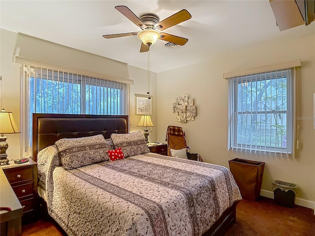 11912 Mcmullen Loop, Riverview, FL 33569 - bedroom featuring dark colored carpet, baseboards, and a ceiling fan