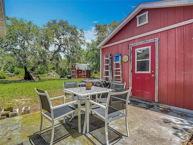 11912 Mcmullen Loop, Riverview, FL 33569 - view of patio / terrace featuring outdoor dining space and view of wooded area