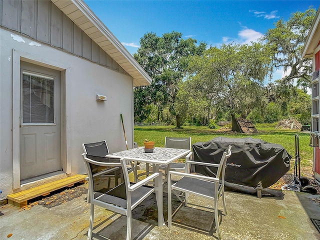 11912 Mcmullen Loop, Riverview, FL 33569 - view of patio featuring outdoor dining space, area for grilling, and view of scattered trees