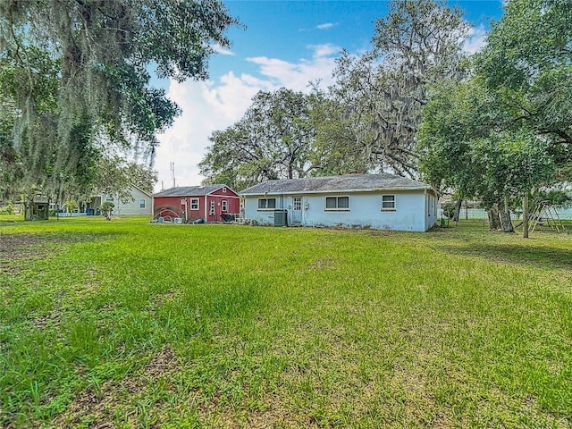 11912 Mcmullen Loop, Riverview, FL 33569 - rear view of property featuring stucco siding, central AC, and a yard