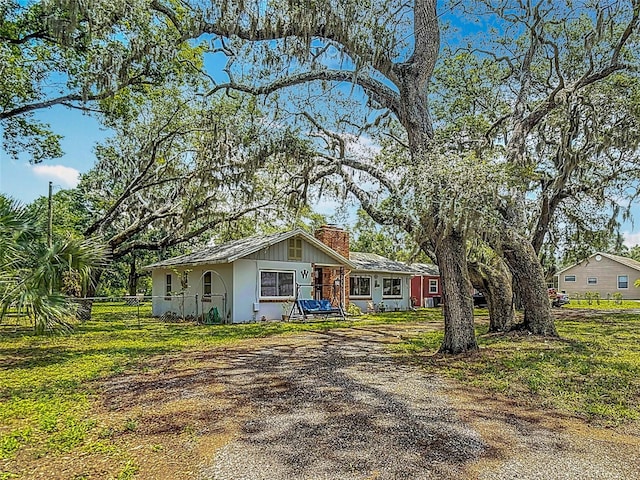 11912 Mcmullen Loop, Riverview, FL 33569 - ranch-style home with a chimney and driveway