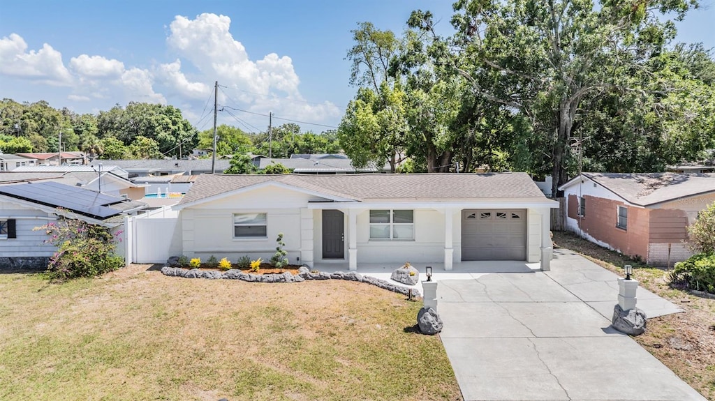 3445 Pinehurst Dr, Holiday, FL 34691 - ranch-style house featuring a garage, driveway, and a shingled roof