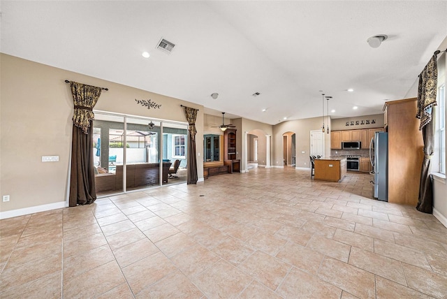 10645 Ruffino Ct, Trinity, FL 34655 - unfurnished living room with baseboards, arched walkways, vaulted ceiling, and recessed lighting