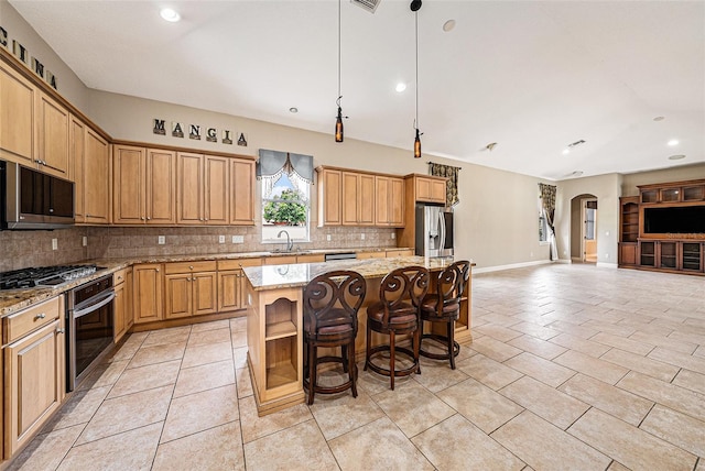 10645 Ruffino Ct, Trinity, FL 34655 - kitchen with stainless steel appliances, a sink, arched walkways, decorative backsplash, and a center island