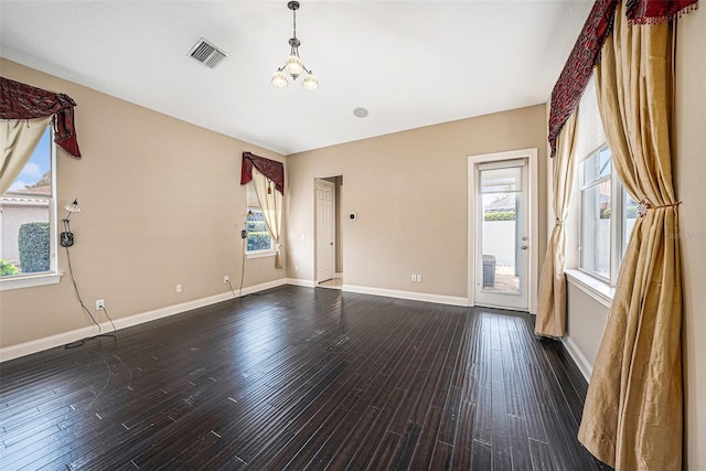 10645 Ruffino Ct, Trinity, FL 34655 - unfurnished room with a chandelier, dark wood-style flooring, and baseboards