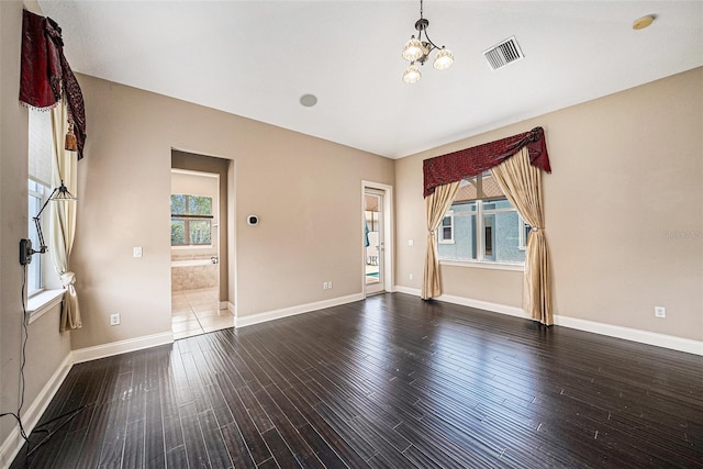10645 Ruffino Ct, Trinity, FL 34655 - spare room featuring hardwood / wood-style flooring, a chandelier, baseboards, and a smoke detector
