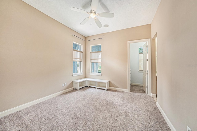 10645 Ruffino Ct, Trinity, FL 34655 - spare room featuring ceiling fan, a textured ceiling, light colored carpet, and baseboards