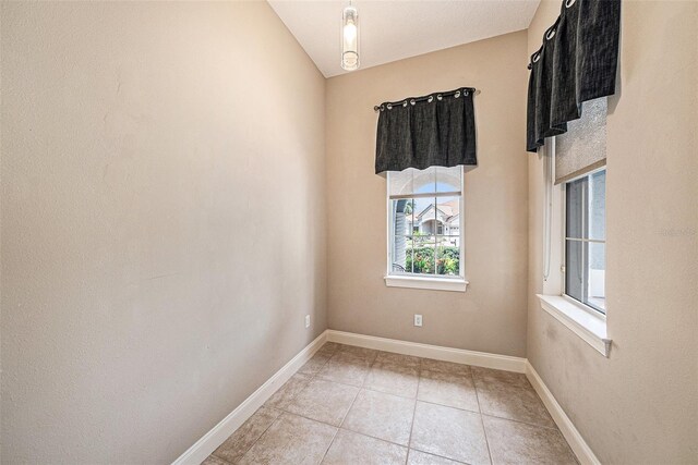 10645 Ruffino Ct, Trinity, FL 34655 - spare room featuring light tile patterned flooring and baseboards