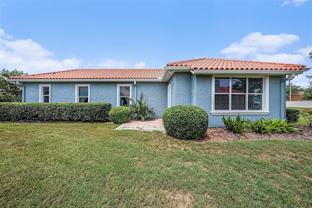 10645 Ruffino Ct, Trinity, FL 34655 - view of front of home featuring a tile roof, a front lawn, and stucco siding