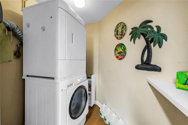 6265 Sun Blvd Unit 605, Saint Petersburg, FL 33715 - washroom with estacked washer and dryer, wood finished floors, and baseboards