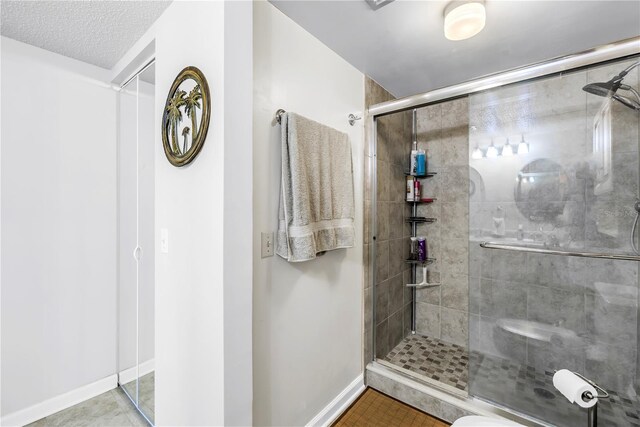 6265 Sun Blvd Unit 605, Saint Petersburg, FL 33715 - full bath with a stall shower, baseboards, tile patterned floors, and toilet