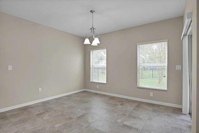 16016 Persimmon Grove Dr, Lithia, FL 33547 - unfurnished room featuring baseboards and a chandelier