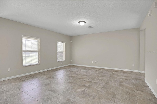 16016 Persimmon Grove Dr, Lithia, FL 33547 - empty room featuring a textured ceiling and baseboards