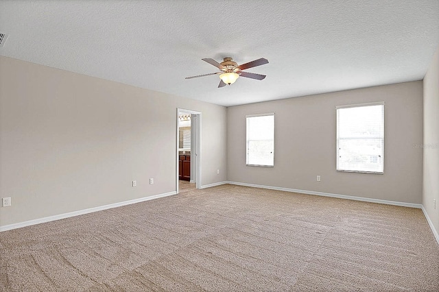 16016 Persimmon Grove Dr, Lithia, FL 33547 - spare room featuring ceiling fan, a textured ceiling, light colored carpet, and baseboards