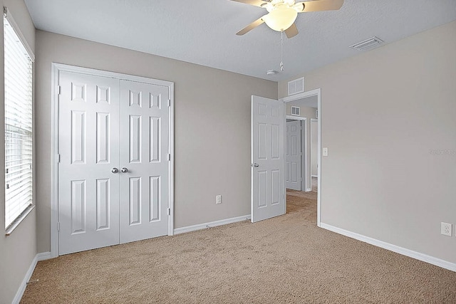 16016 Persimmon Grove Dr, Lithia, FL 33547 - unfurnished bedroom with light colored carpet, a closet, baseboards, and a ceiling fan