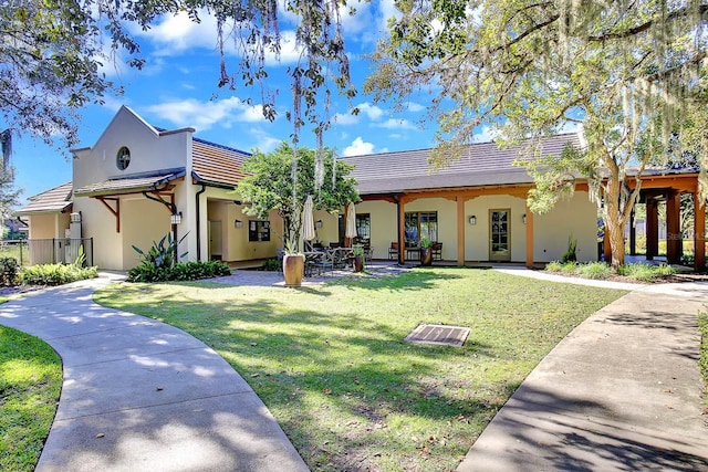 16016 Persimmon Grove Dr, Lithia, FL 33547 - view of front of house featuring a front lawn, stucco siding, and a patio area