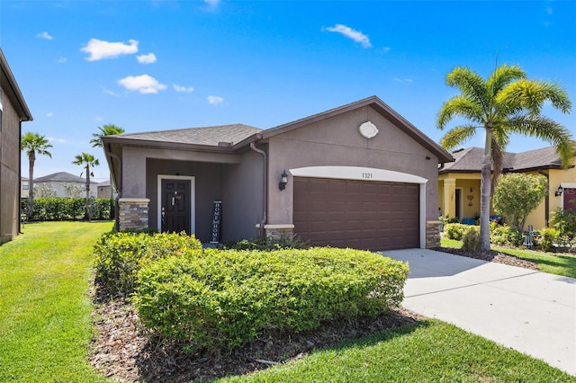 1321 Custer Bayou St, Ruskin, FL 33570 - ranch-style home with stone siding, an attached garage, stucco siding, a front lawn, and concrete driveway