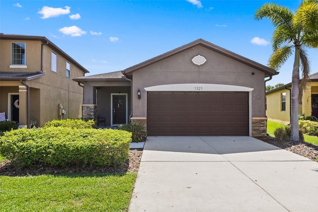 1321 Custer Bayou St, Ruskin, FL 33570 - view of front of home with stone siding, stucco siding, an attached garage, and driveway