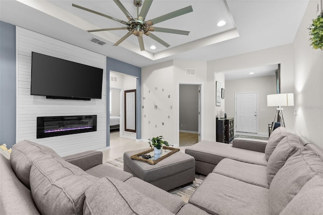 1321 Custer Bayou St, Ruskin, FL 33570 - living room with a ceiling fan, recessed lighting, baseboards, a raised ceiling, and a large fireplace