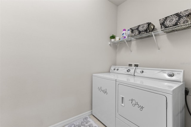 1321 Custer Bayou St, Ruskin, FL 33570 - washroom featuring washer and clothes dryer, baseboards, and light tile patterned floors