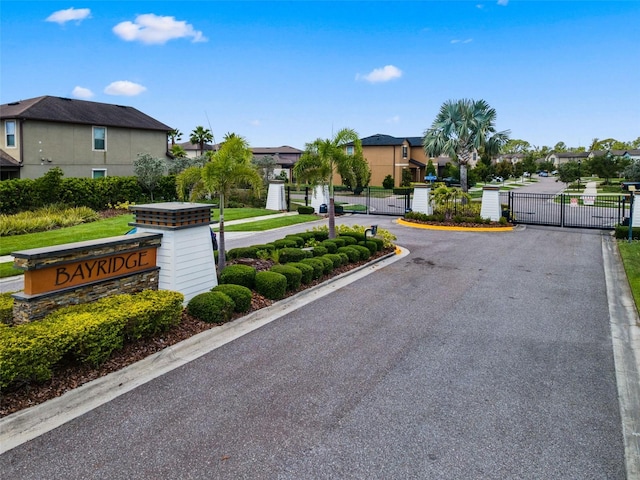 1321 Custer Bayou St, Ruskin, FL 33570 - view of asphalt street with a gate, a residential view, curbs, and a gated entry