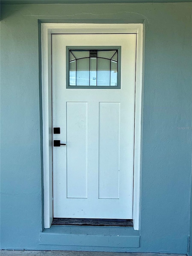 440 89th Ave, St Pete Beach, FL 33706 - doorway to property featuring stucco siding
