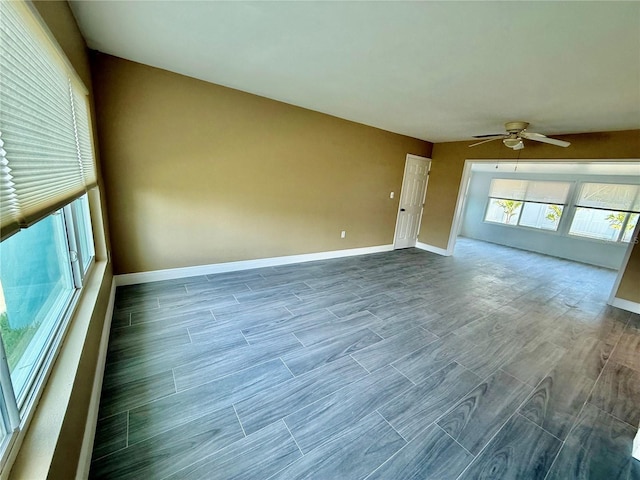 440 89th Ave, St Pete Beach, FL 33706 - spare room featuring a ceiling fan, wood tiled floors, and baseboards