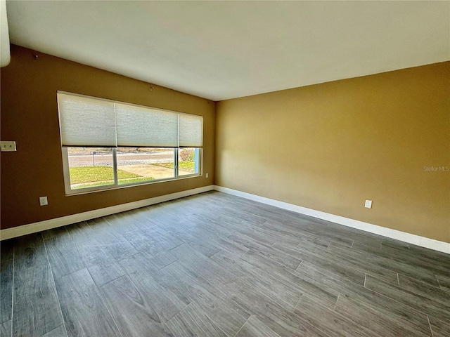 440 89th Ave, St Pete Beach, FL 33706 - empty room with baseboards and wood finished floors