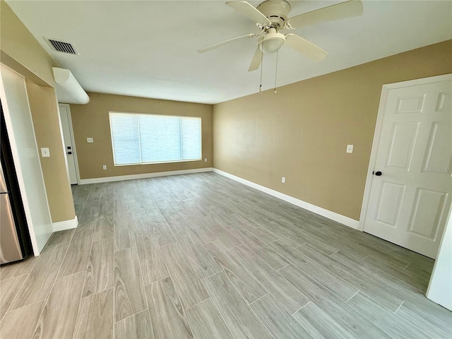 440 89th Ave, St Pete Beach, FL 33706 - empty room featuring light wood finished floors, ceiling fan, and baseboards