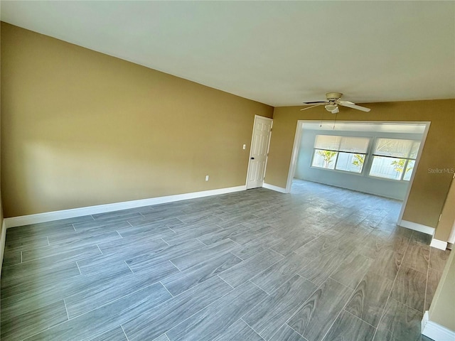 440 89th Ave, St Pete Beach, FL 33706 - empty room with ceiling fan, wood finished floors, and baseboards