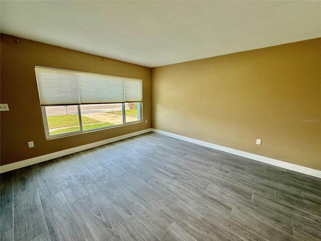 440 89th Ave, St Pete Beach, FL 33706 - unfurnished room featuring baseboards and wood finished floors