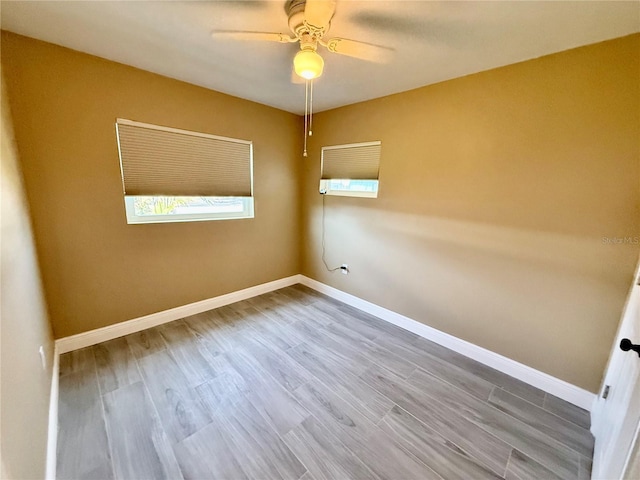 440 89th Ave, St Pete Beach, FL 33706 - spare room featuring a ceiling fan, wood finished floors, and baseboards