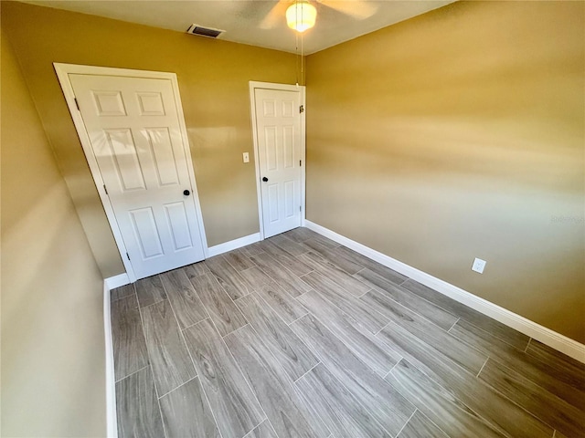 440 89th Ave, St Pete Beach, FL 33706 - unfurnished bedroom featuring baseboards and wood tiled floors