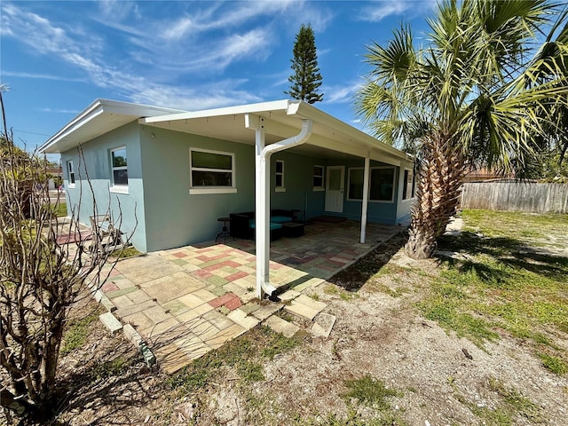 440 89th Ave, St Pete Beach, FL 33706 - rear view of house with stucco siding and a patio area