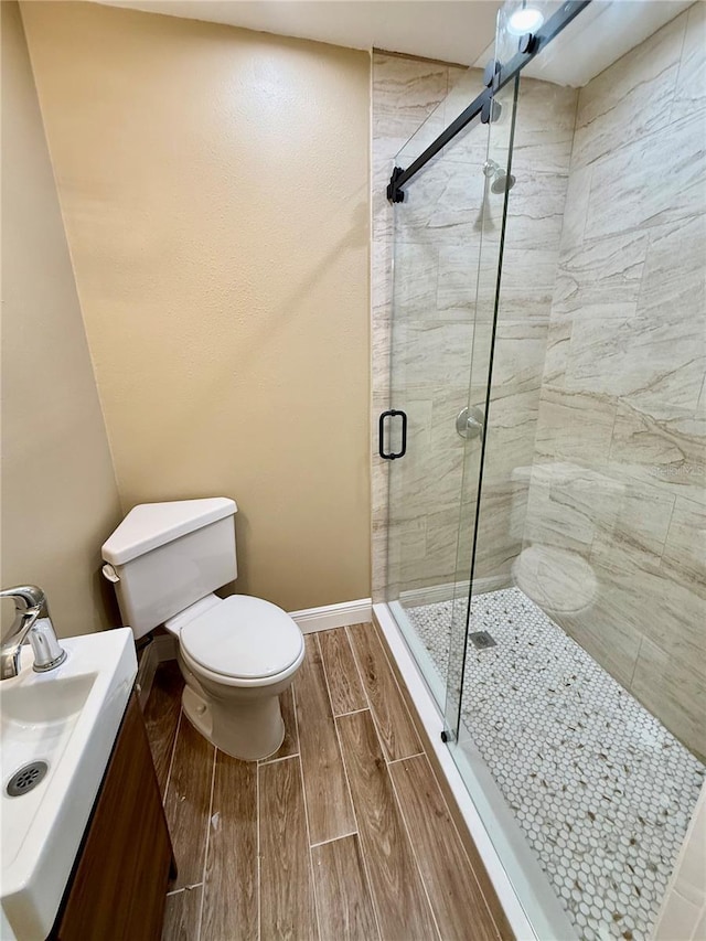440 89th Ave, St Pete Beach, FL 33706 - full bath featuring a stall shower, toilet, wood finish floors, and baseboards