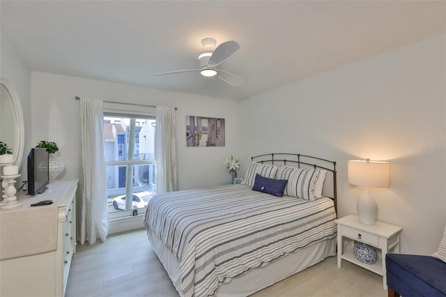 230 Medallion Blvd Unit F, Madeira Beach, FL 33708 - bedroom featuring light wood-style flooring and ceiling fan