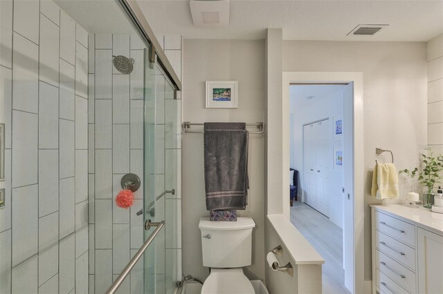 230 Medallion Blvd Unit F, Madeira Beach, FL 33708 - bathroom featuring toilet, a shower stall, and vanity