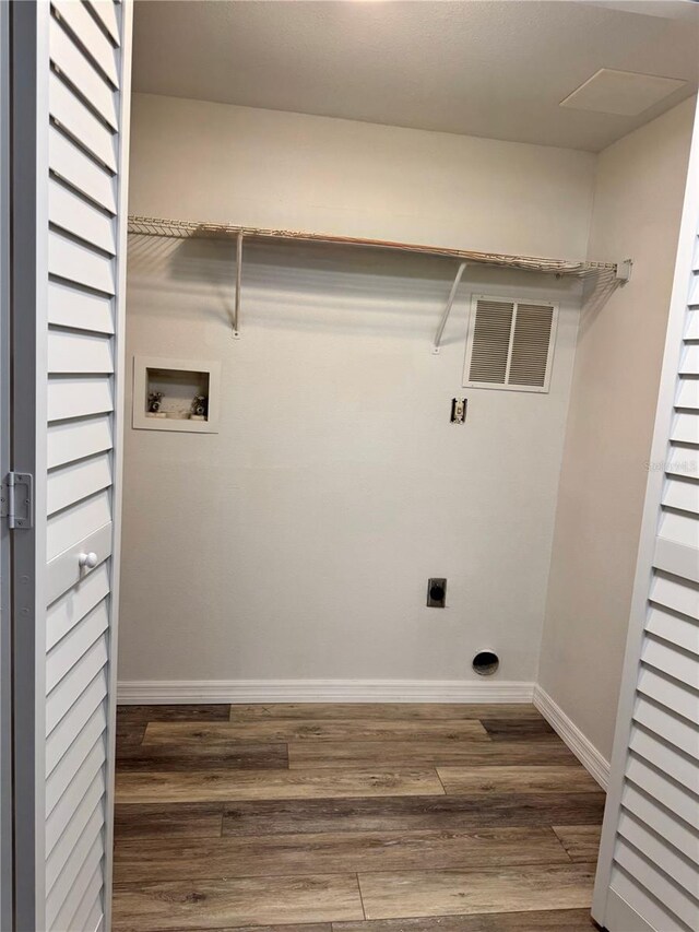 2690 Coral Landings Blvd Unit 217, Palm Harbor, FL 34684 - laundry area with hookup for an electric dryer, hookup for a washing machine, wood finished floors, and baseboards