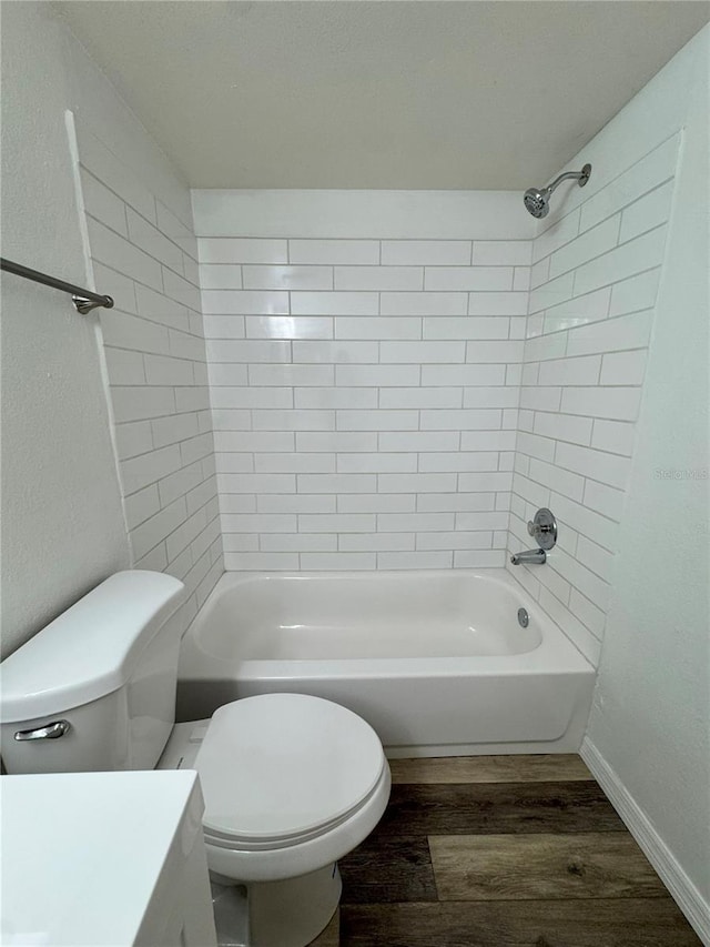 2690 Coral Landings Blvd Unit 217, Palm Harbor, FL 34684 - full bath featuring wood finished floors, toilet, vanity, bathtub / shower combination, and baseboards