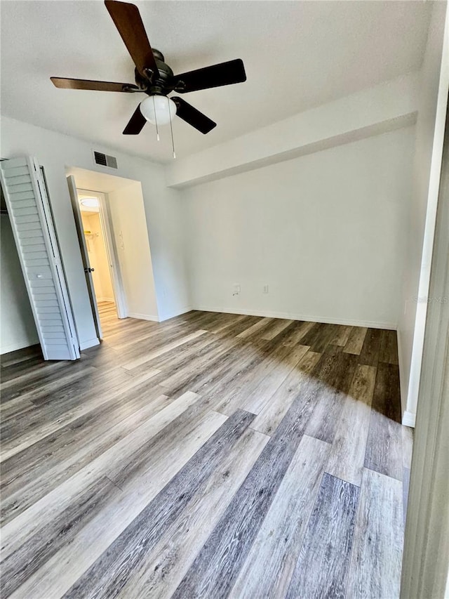 2690 Coral Landings Blvd Unit 217, Palm Harbor, FL 34684 - unfurnished bedroom with wood finished floors and a ceiling fan